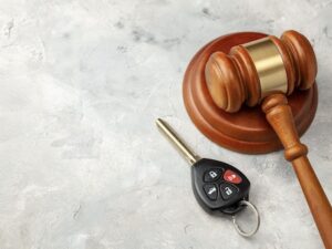 Car Accident. Judge Gavel And Car Bleeding With Alarm. Car Insurance Solution
